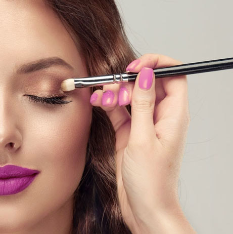 Makeup artist applies eye shadow 1200x628 cropped